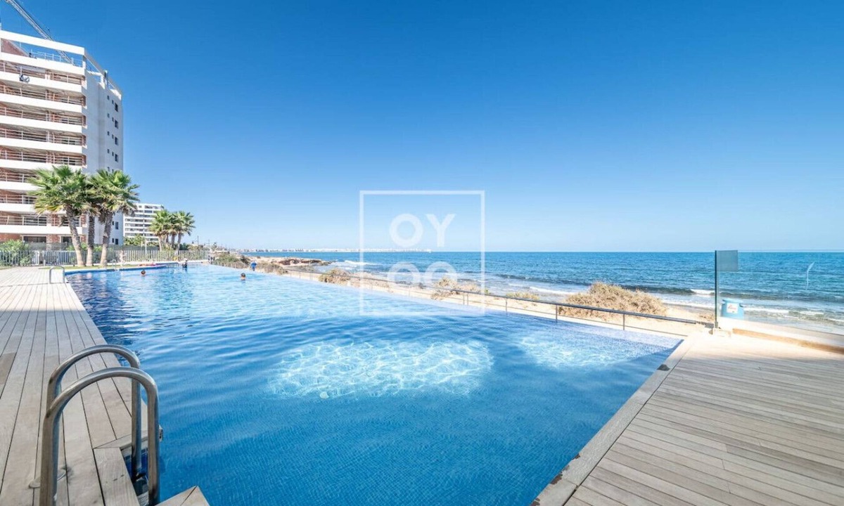 Punta Prima Apartment | Infinity Blue groundfloor apt, beachfront, heated pool - by OYOOSTAYS