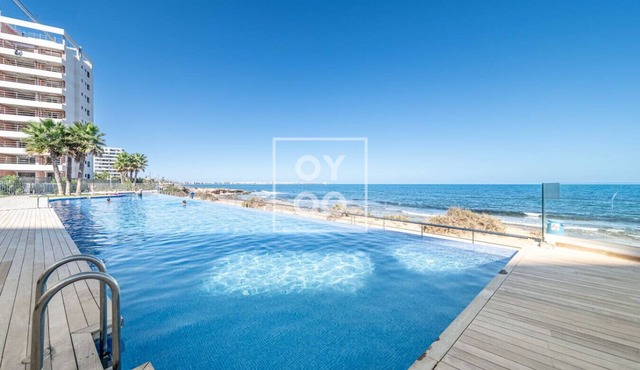 Infinity Blue groundfloor apt, beachfront, heated pool - by OYOOSTAYS